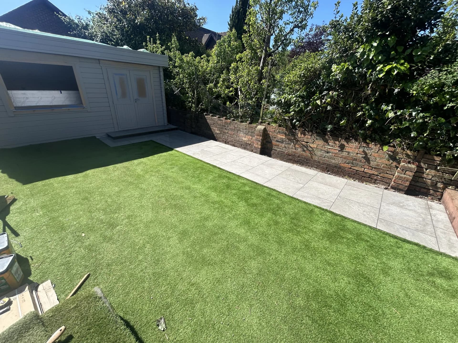 Garden landscaping with artificial grass and summer house in Cardiff